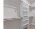 Bright walk-in closet features custom built-in shelving and clothing racks for optimal organization at 730 Hopkins St, Durham, NC 27701
