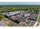 Aerial view of a complex of brick buildings with ample parking, set amidst lush greenery and cityscape views at 732 Hopkins St, Durham, NC 27701