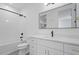 Stylish bathroom with a modern vanity, a tub-shower combo and sleek matte black fixtures at 732 Hopkins St, Durham, NC 27701