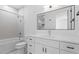 Bright bathroom with a bathtub, shower, and white vanity at 732 Hopkins St, Durham, NC 27701