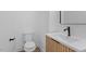 Bright bathroom with a toilet, sink, and modern faucet at 732 Hopkins St, Durham, NC 27701