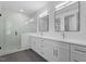Modern bathroom featuring double vanity, quartz countertop, and luxurious glass-enclosed shower at 732 Hopkins St, Durham, NC 27701