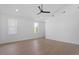 Bedroom features a ceiling fan, hardwood floors, and windows with neighborhood views at 732 Hopkins St, Durham, NC 27701