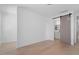 Bright bedroom with light wood floors and barn door leading to ensuite bathroom at 732 Hopkins St, Durham, NC 27701