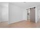 Open bedroom view includes hardwood floors, neutral walls, and a peek into the bathroom at 732 Hopkins St, Durham, NC 27701