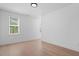 Bright bedroom features neutral color palette, hardwood floors, and window with a neighborhood view at 732 Hopkins St, Durham, NC 27701