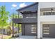 Modern home with black and white exterior, multiple balconies, and attached garages at 732 Hopkins St, Durham, NC 27701
