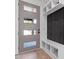 Foyer featuring a modern door with glass panes, built-in storage, and a stylish wall panel at 732 Hopkins St, Durham, NC 27701