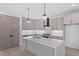 Bright kitchen features a large island with a sink, modern appliances, and ample cabinet space at 732 Hopkins St, Durham, NC 27701