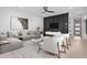 Living room with stylish decor, a gray sofa, modern art, and hardwood floors at 732 Hopkins St, Durham, NC 27701
