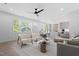 Open living room showcasing modern furniture, a gray sofa, an island and a dining space with natural light at 732 Hopkins St, Durham, NC 27701