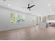 Bright living area features hardwood floors, ceiling fan, and many windows with neighborhood views at 732 Hopkins St, Durham, NC 27701