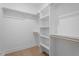 White open shelving in a spacious walk-in closet with wood flooring at 732 Hopkins St, Durham, NC 27701
