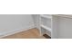 Close-up view of custom shelving in a walk-in closet with wood flooring at 732 Hopkins St, Durham, NC 27701