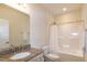Bright bathroom featuring a white shower-tub, granite countertop sink, and a large mirror at 74 Revelstoke Dr, Garner, NC 27529