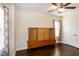Bedroom with a ceiling fan, hardwood floors, two windows, and a wooden cabinet at 74 Revelstoke Dr, Garner, NC 27529