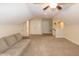 A bonus room featuring a comfortable sofa and neutral color palette at 74 Revelstoke Dr, Garner, NC 27529