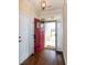 Welcoming entryway featuring a hardwood floor, a red front door, and abundant natural light at 74 Revelstoke Dr, Garner, NC 27529