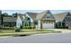 Charming home with a blue exterior, stone accents, and well-manicured lawn at 74 Revelstoke Dr, Garner, NC 27529