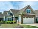 Charming two-story home boasting a well-manicured lawn, stone accents, and a spacious two car garage at 74 Revelstoke Dr, Garner, NC 27529