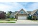 Beautiful two-story home with a well-kept lawn, stone accents, and a spacious driveway providing ample parking at 74 Revelstoke Dr, Garner, NC 27529