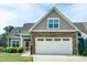 Charming two-story home featuring a stone facade, two-car garage, and manicured lawn at 74 Revelstoke Dr, Garner, NC 27529