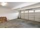 A clean, empty two car garage provides ample parking and storage space with a garage door and cement floor at 74 Revelstoke Dr, Garner, NC 27529
