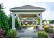 Relaxing gazebo with benches and manicured landscaping that offers a serene community gathering space at 74 Revelstoke Dr, Garner, NC 27529