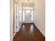 Hallway leading to front door, featuring hardwood floors and white trim at 74 Revelstoke Dr, Garner, NC 27529