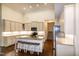 Spacious kitchen featuring white cabinets, granite countertops, island seating and hardwood floors at 74 Revelstoke Dr, Garner, NC 27529