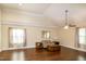 Bright living room boasts hardwood floors, high ceilings and natural light from the many windows at 74 Revelstoke Dr, Garner, NC 27529