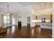 Open living room with hardwood floors, fireplace, and kitchen with bar seating at 74 Revelstoke Dr, Garner, NC 27529