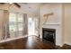 Living room featuring a fireplace, hardwood floors, and access to the patio at 74 Revelstoke Dr, Garner, NC 27529