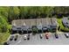 An aerial view of townhomes with ample parking, set among lush green trees at 7613 Satinwing Ln, Raleigh, NC 27617
