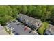 An aerial perspective showcases homes with dedicated parking and surrounded by lush greenery at 7613 Satinwing Ln, Raleigh, NC 27617