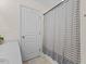 Bathroom featuring a white vanity, framed mirror and gray and white striped shower curtain at 7613 Satinwing Ln, Raleigh, NC 27617