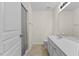 Bright bathroom featuring a white vanity, modern fixtures and a shower with a gray and white striped curtain at 7613 Satinwing Ln, Raleigh, NC 27617