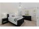 Bedroom with a bed, carpet, ceiling fan, and natural lighting from the windows at 7613 Satinwing Ln, Raleigh, NC 27617