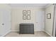 Cozy bedroom with neutral walls, framed art, and a gray dresser at 7613 Satinwing Ln, Raleigh, NC 27617