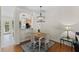 Cozy dining room with a wooden table and decorative light fixture at 7613 Satinwing Ln, Raleigh, NC 27617