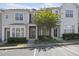 Lovely townhome with an appealing facade, beautiful greenery, and a paved parking area for easy access at 7613 Satinwing Ln, Raleigh, NC 27617