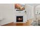 Elegant fireplace with a white mantel and a TV mounted above at 7613 Satinwing Ln, Raleigh, NC 27617