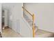 Hallway with a staircase and multiple doors with neutral color palette at 7613 Satinwing Ln, Raleigh, NC 27617