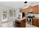 Bright kitchen with an island, stainless steel appliances, and natural light at 7613 Satinwing Ln, Raleigh, NC 27617