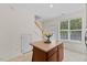 Kitchen nook featuring a central island with storage, a window letting in natural light, and access to stairs and a door at 7613 Satinwing Ln, Raleigh, NC 27617