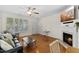 Spacious living room with large windows and a cozy fireplace at 7613 Satinwing Ln, Raleigh, NC 27617