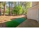 Townhouse backyard with a small porch and an exterior storage closet at 7707 Falcon Rest Cir, Raleigh, NC 27615