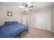 This bedroom features carpet, ceiling fan and a closet with bi-fold doors at 7707 Falcon Rest Cir, Raleigh, NC 27615