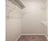 Walk-in closet with carpet and ample shelving for organized storage solutions at 7707 Falcon Rest Cir, Raleigh, NC 27615