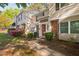 Townhouse with brick accents, landscaping and a red front door at 7707 Falcon Rest Cir, Raleigh, NC 27615